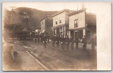Postcard Military Soldiers Parade Rural Street Scene Shops Signs RPPC T112 picture