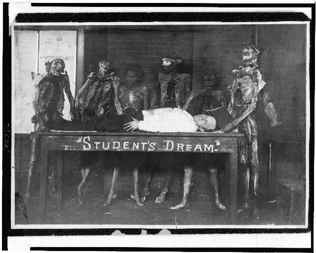 Man lying,table labeled,student's dream,surrounded,figures,mummies,dead,1900